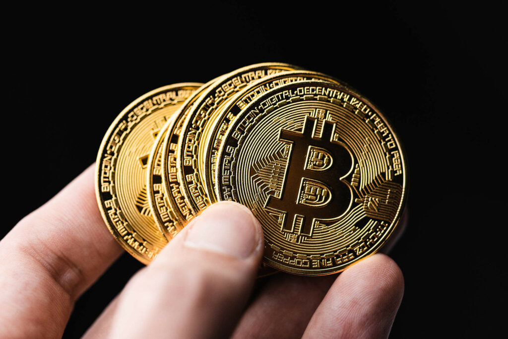 Holding Bitcoins in a Hand 2210x1473 1 1024x683.jpeg